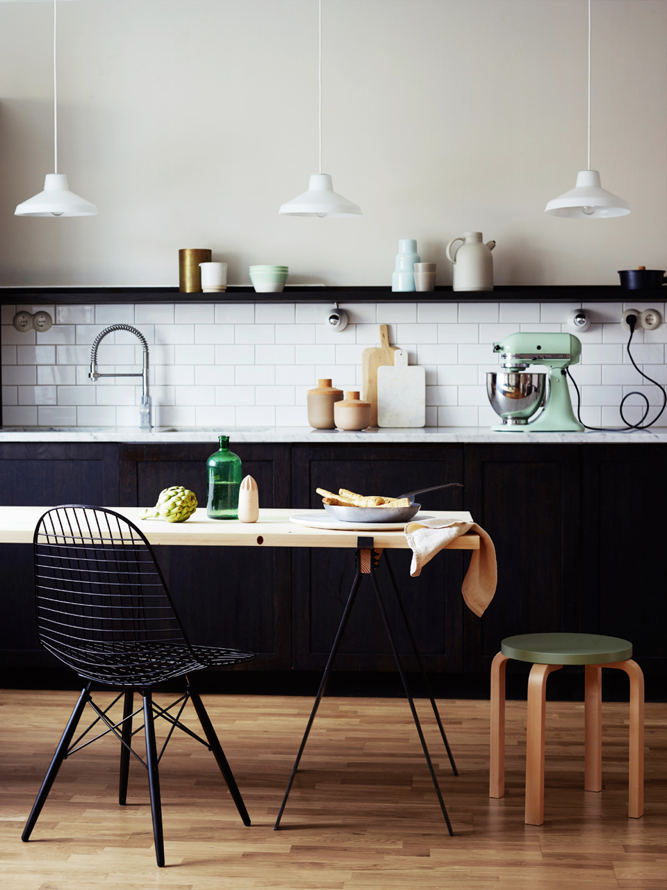 #Marble bench and #subway tiles paired with simple pendants and table give this #black kitchen featured in Elle an industrial vibe. From The #Monochrome #Kitchen, the RSD Blog.