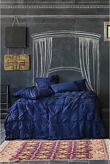 Rosette Quilt in Petrol by Anthropologie set against a dark and imaginative chalkboard wall. More #blue goodness on the RSD Blog.
